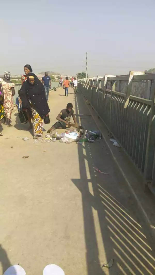 2 Physically Challenged Men Sweep Abuja Pedestrian Bridge(Pics)